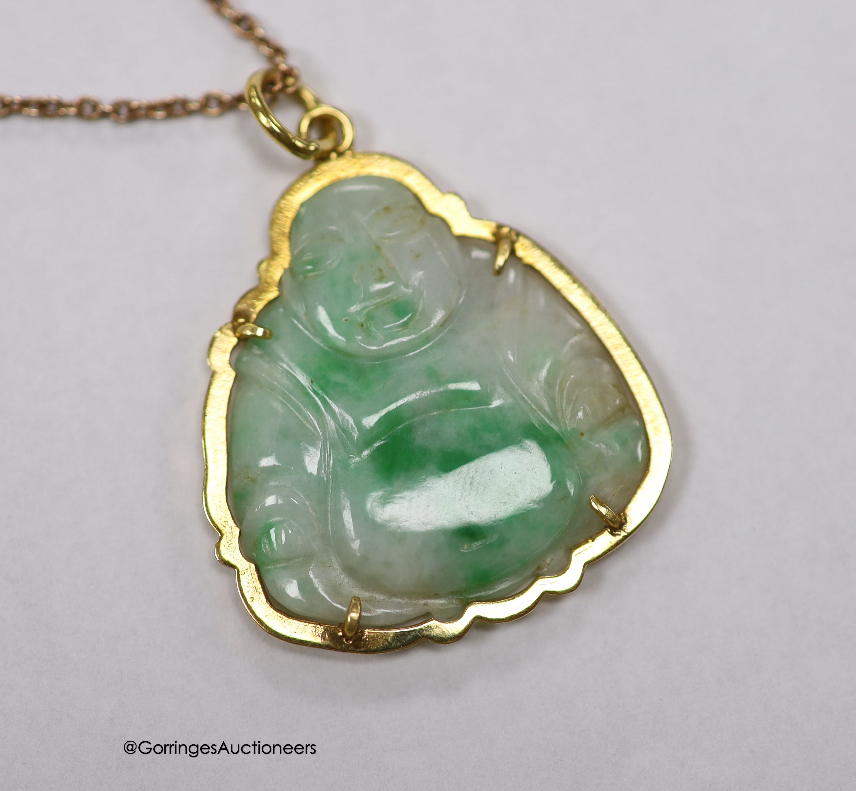 A yellow metal mounted jade pendant, carved as a Buddha, 30mm on a 925 chain.